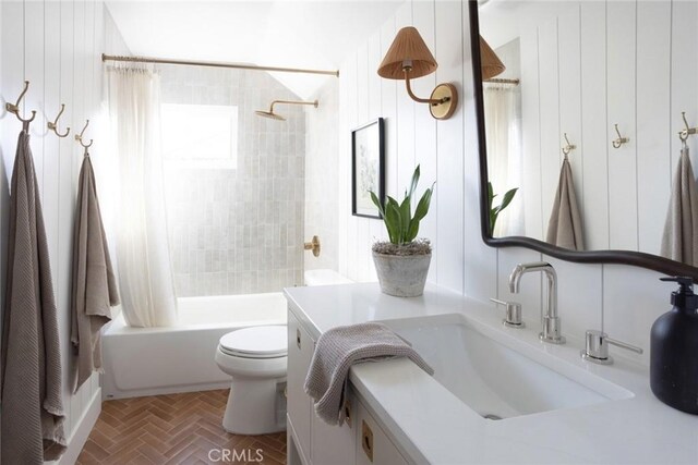 full bathroom with toilet, vanity, wooden walls, and shower / bath combination with curtain