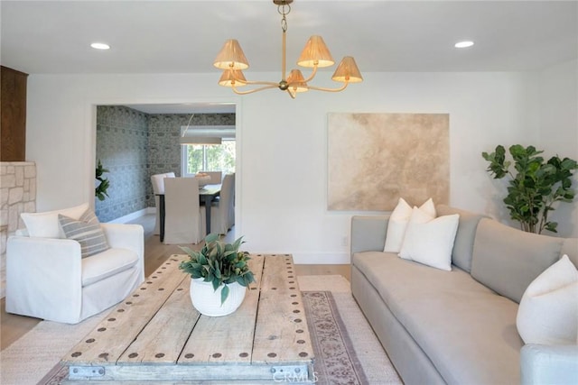 living room with light hardwood / wood-style flooring and a notable chandelier