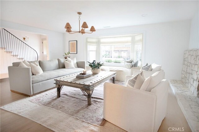 living room featuring light hardwood / wood-style flooring and a chandelier