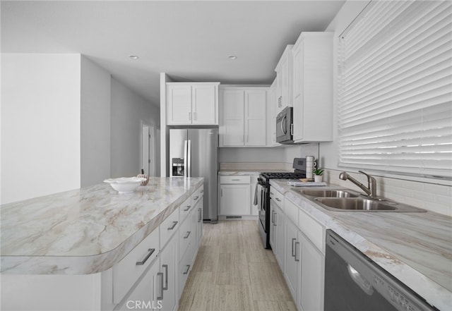 kitchen featuring a kitchen island, sink, white cabinets, and black appliances