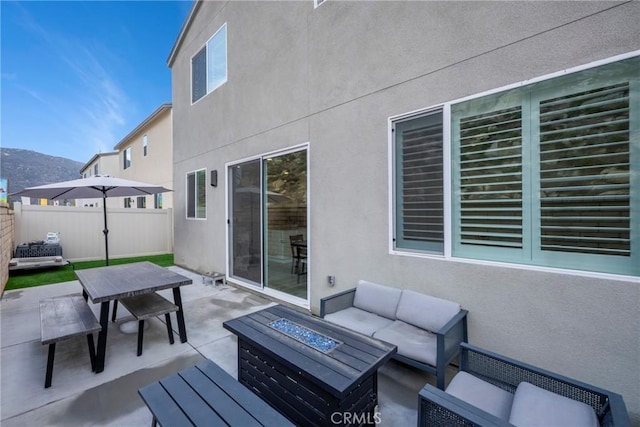 view of patio / terrace with an outdoor living space with a fire pit and a mountain view