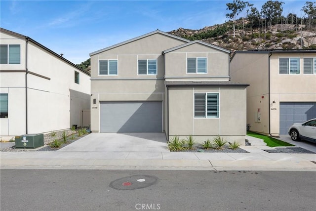 view of front of home featuring a garage and central air condition unit