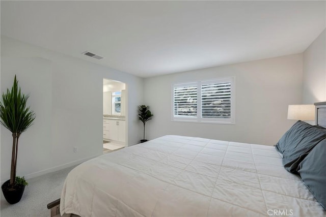 carpeted bedroom with connected bathroom