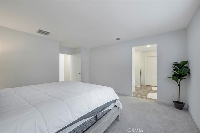 bedroom featuring light carpet