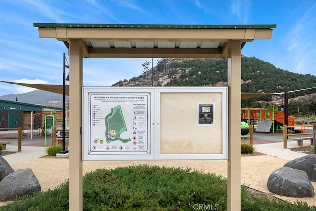 view of property's community with a mountain view and a playground