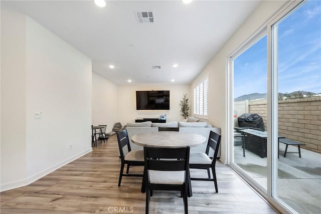 dining area with light hardwood / wood-style floors