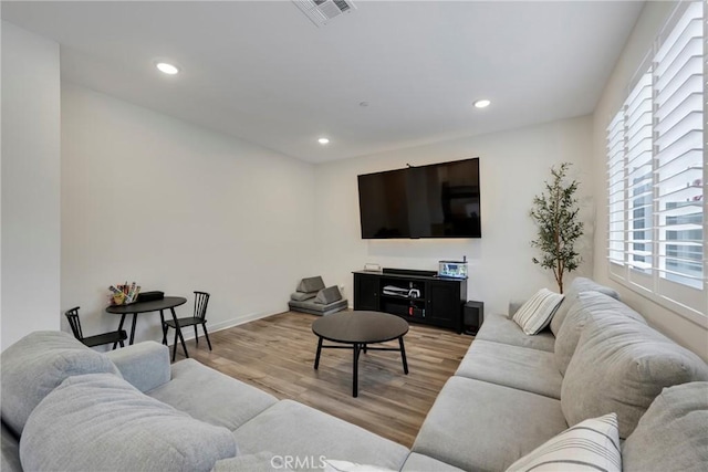 living room featuring plenty of natural light and light hardwood / wood-style floors