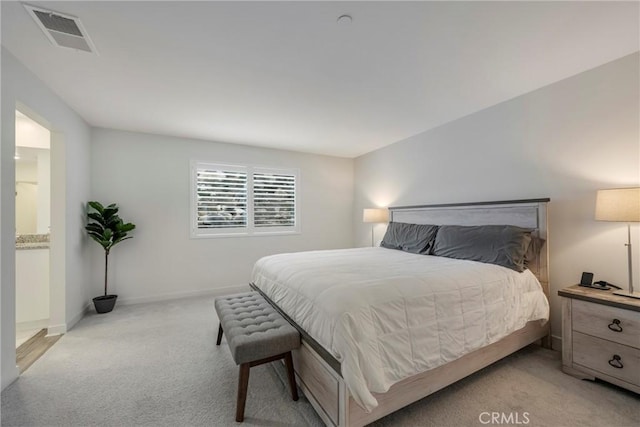 carpeted bedroom with ensuite bathroom