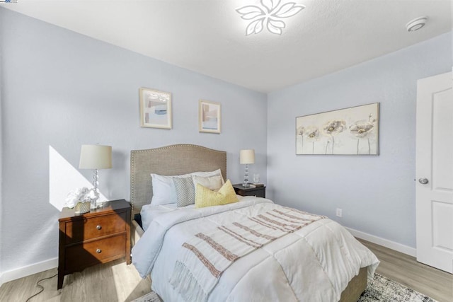 bedroom with light hardwood / wood-style floors