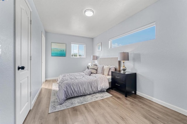 bedroom with light hardwood / wood-style floors