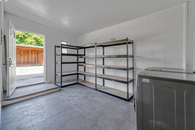 storage area featuring washing machine and clothes dryer