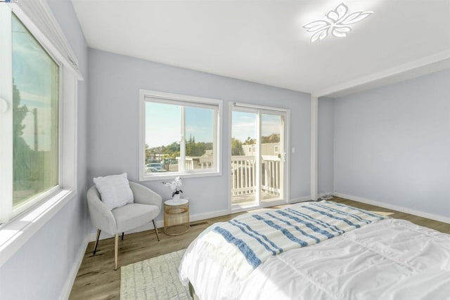 bedroom featuring access to outside and light wood-type flooring