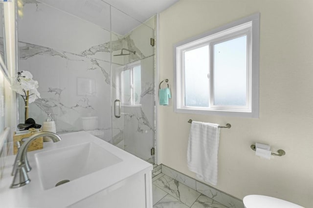 bathroom with toilet, vanity, and an enclosed shower