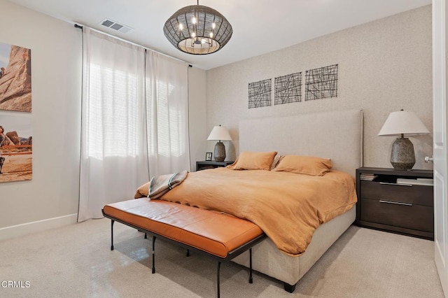 bedroom with light carpet and a chandelier