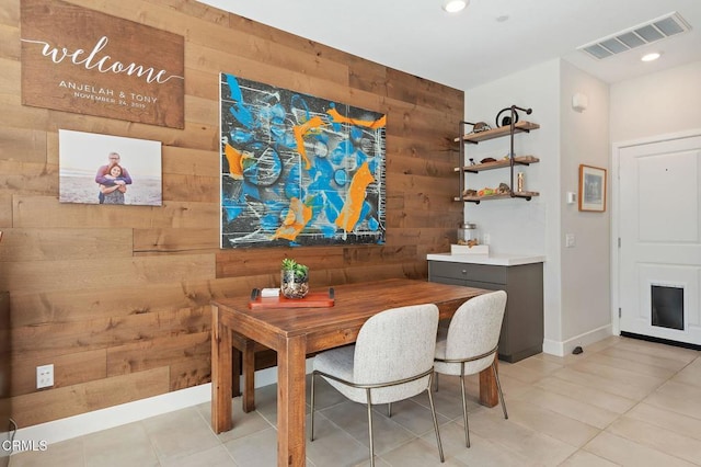 tiled dining area with wooden walls