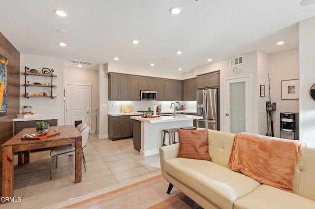 living room with sink and light tile patterned floors