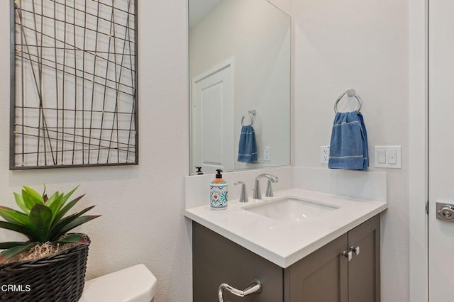 bathroom featuring toilet and vanity