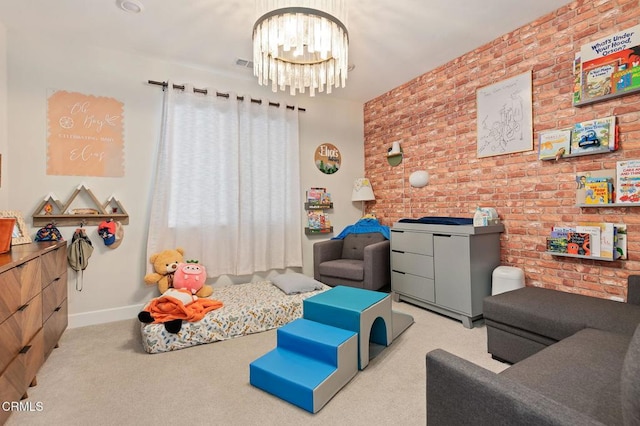 playroom featuring light colored carpet, brick wall, and a chandelier