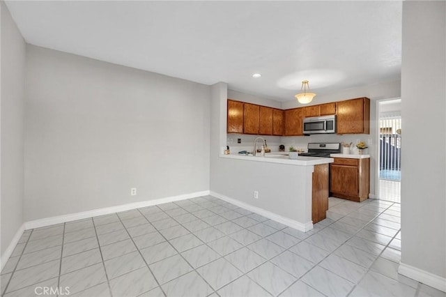 kitchen with kitchen peninsula, sink, hanging light fixtures, stainless steel appliances, and light tile patterned floors