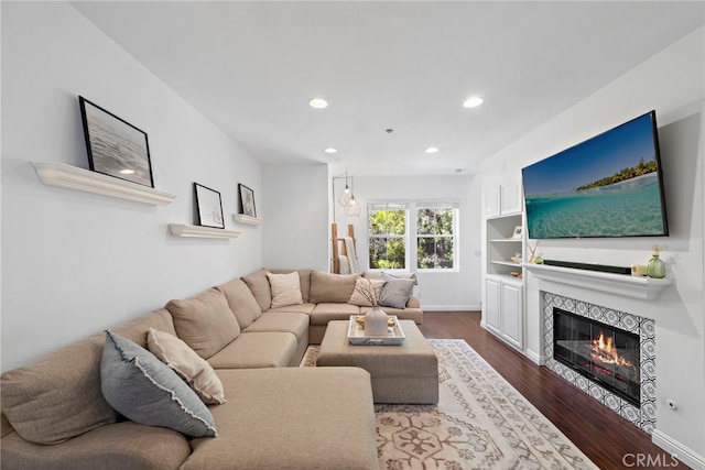 living room featuring dark hardwood / wood-style floors and a tile fireplace