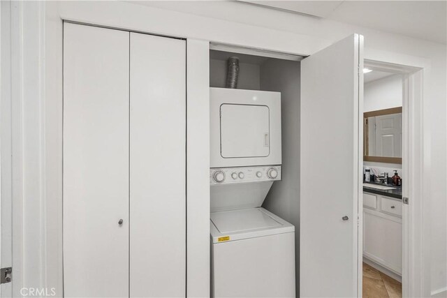 laundry room with stacked washer / dryer