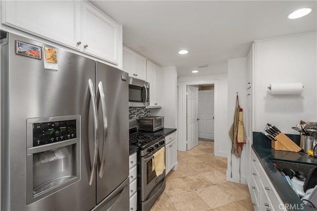 kitchen featuring backsplash, stainless steel appliances, and white cabinets