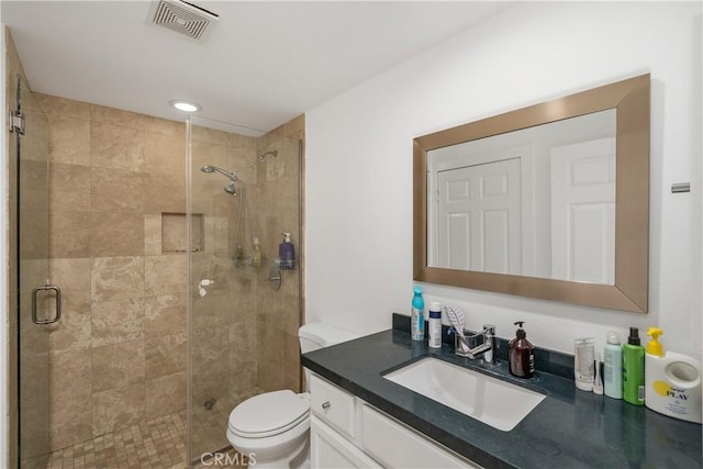 bathroom with vanity, toilet, and an enclosed shower