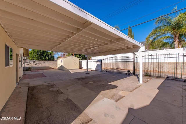 view of patio / terrace with a storage unit and a carport