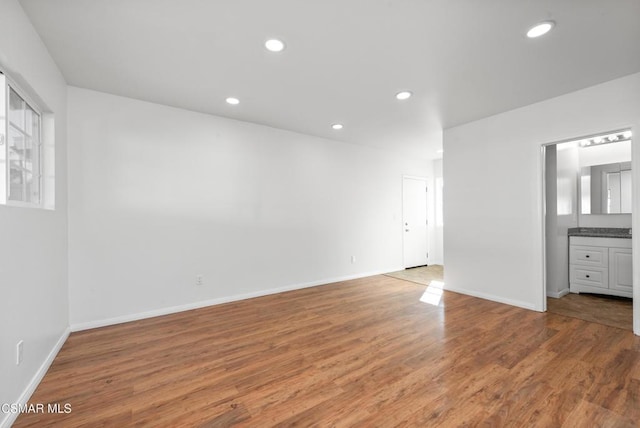 unfurnished room with hardwood / wood-style flooring