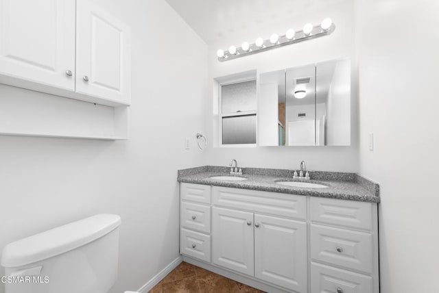 bathroom featuring toilet, tile patterned floors, and vanity