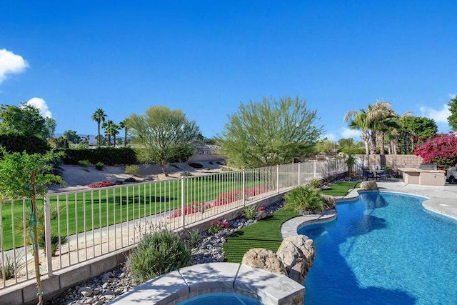 view of pool featuring a jacuzzi and a lawn