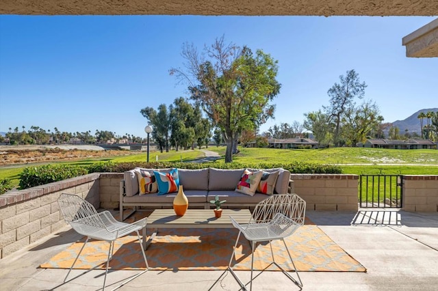 view of patio featuring an outdoor living space and a mountain view