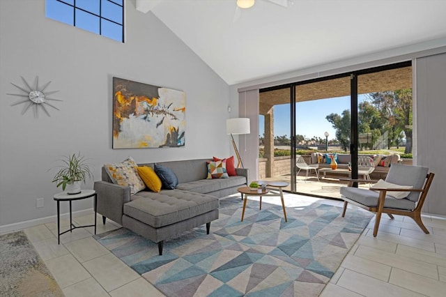 living room with a towering ceiling, a wealth of natural light, and light tile patterned floors