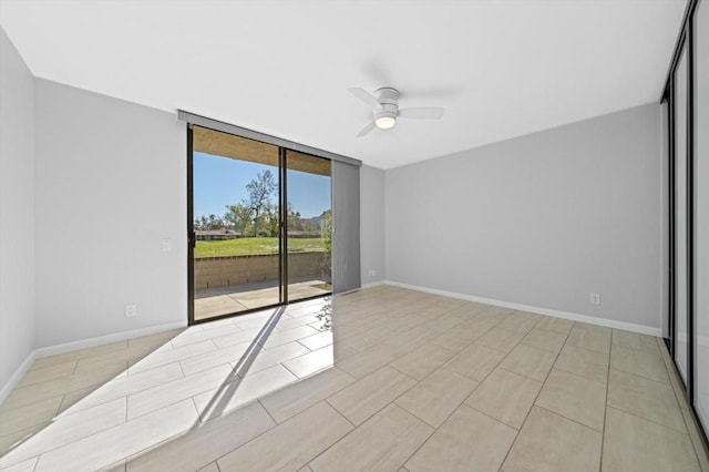 unfurnished room featuring ceiling fan and floor to ceiling windows