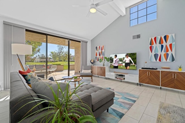 living room featuring a high ceiling, light tile patterned floors, ceiling fan, and beamed ceiling