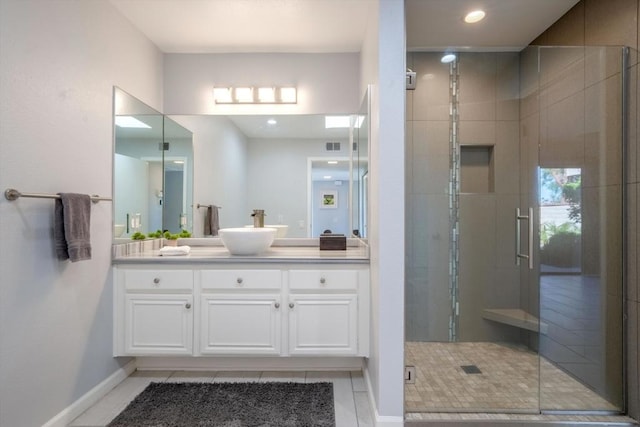 bathroom with tile patterned flooring, vanity, and a shower with shower door