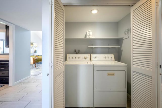 laundry room featuring light tile patterned floors and washing machine and dryer