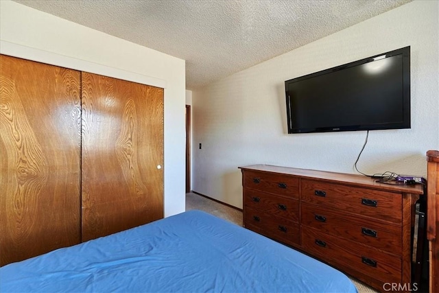 bedroom with a closet and a textured ceiling