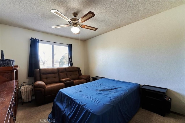 carpeted bedroom with a textured ceiling and ceiling fan