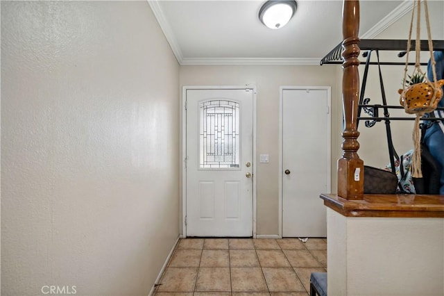 entrance foyer featuring ornamental molding and light tile patterned flooring