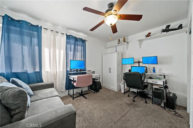 carpeted office space with ceiling fan