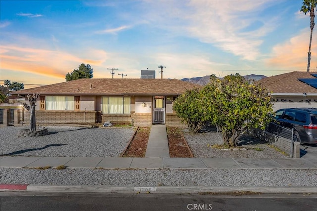 single story home featuring a mountain view and a garage