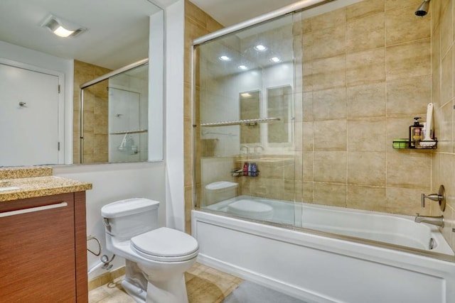 full bathroom featuring toilet, enclosed tub / shower combo, and vanity