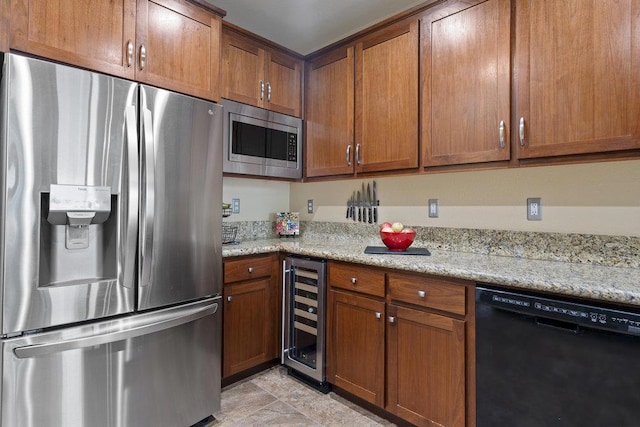 kitchen with light stone counters, appliances with stainless steel finishes, and wine cooler