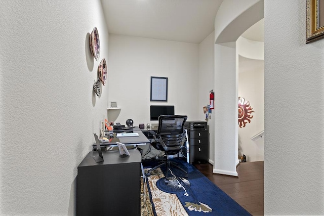 home office with dark hardwood / wood-style floors