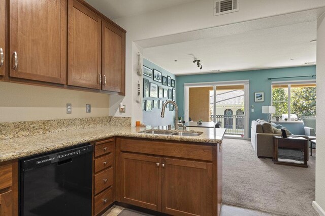 kitchen featuring sink, light colored carpet, black dishwasher, and kitchen peninsula