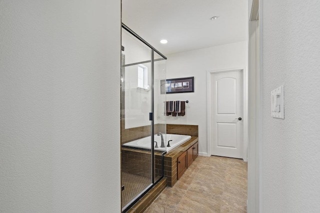 bathroom featuring independent shower and bath