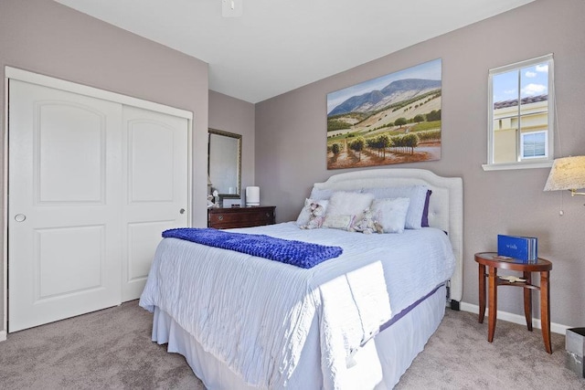 bedroom with light colored carpet and a closet