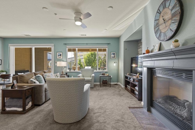 living room featuring ceiling fan and light colored carpet