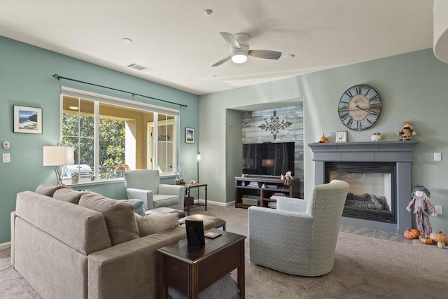 carpeted living room with ceiling fan and a multi sided fireplace